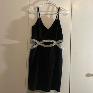 Beautiful black mini dress with jeweled cut outs.